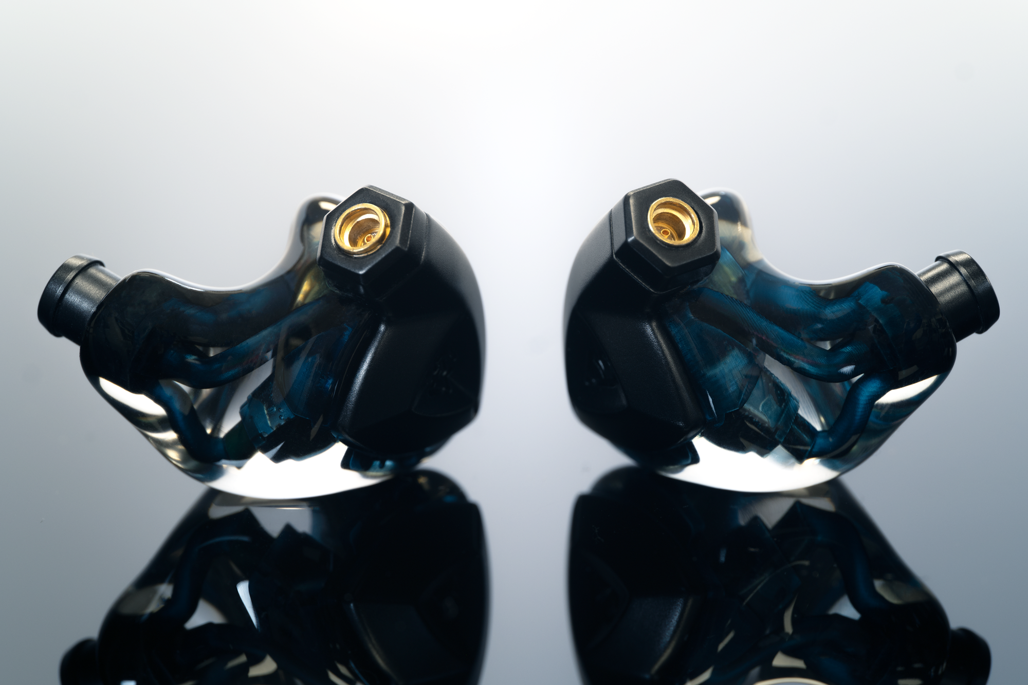 Campfire Audio Clara earphones on reflective black surface